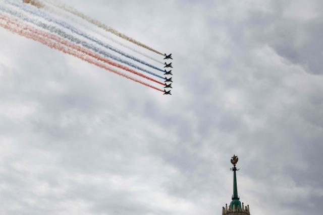 Russian Sukhoi SU-25 fighter jets release smoke in the colours of the Russian tricolor flag as they fly over central Moscow during the Victory Day military parade on May 9, 2026. Russia celebrates the 81st anniversary of the Soviet Union's victory over Nazi Germany in World War Two (WWII). (Photo by TATYANA MAKEYEVA / AFP)