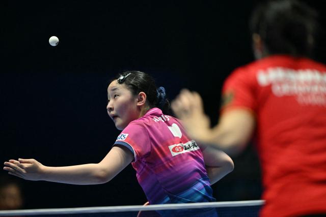 Japan's Miwa Harimoto plays against German's Ying Han during their Women's Teams semifinal match at the ITTF World Table Tennis Championships in Wembley Arena, west London on May 9, 2026. (Photo by Glyn KIRK / AFP)