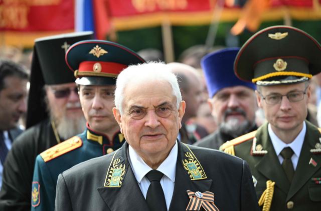 Russia's ambassador to Germany Sergey Nechayev (C) pays his respect at the Soviet War Memorial Tiergarten in Berlin on May 9, 2026 in commemoration of the 81st anniversary of the 1945 victory against Nazi Germany. (Photo by RALF HIRSCHBERGER / AFP)