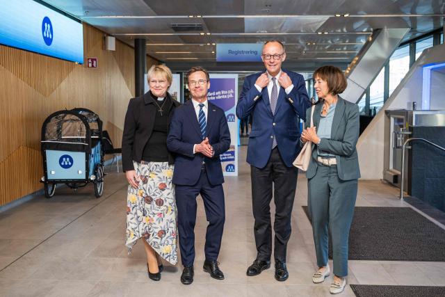 Sweden’s Prime Minister Ulf Kristersson (2nd L) and his wife Birgitta Ed (L) pose with German Chancellor and Chairman of Germany's conservative Christian Democratic Union (CDU) party Friedrich Merz (2nd R) and his wife Charlotte Merz (R) as they arrive to attend Sweden's Moderate party's convention on May 9, 2026 in Stockholm. (Photo by Jonathan NACKSTRAND / AFP)
