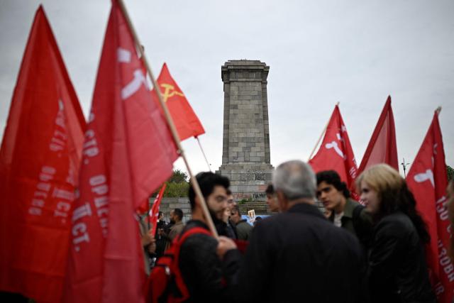 People wave Soviet Union flags in front of the dismentled Soviet Army monument during a celebration of the Victory Day marking the anniversary of the victory over Nazi Germany during World War II, in Sofia on May 9, 2026. Pro-Russian circles in Bulgaria remain divided over the prospects for improved relations with Russia following Rumen Radev’s assumption of the office of prime minister. (Photo by Nikolay DOYCHINOV / AFP)