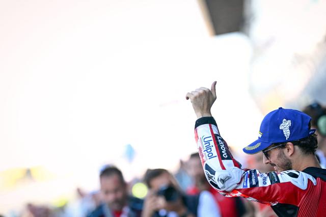 Ducati Lenovo Team's Italian rider Francesco Bagnaia celebrates after setting the fastest time in qualifying to take pole position ahead of the Moto GP Grand Prix of France at Le Mans, northwestern France, on May 9, 2026. (Photo by Loic VENANCE / AFP)