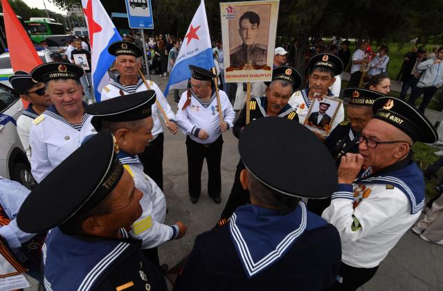 Participants carry portraits of World War Two soldiers during the Immortal Regiment march in Bishkek on May 9, 2026. Kyrgyzstan celebrates the 81st anniversary of the Allied victory over Nazi Germany in World War II. (Photo by Vyacheslav OSELEDKO / AFP)