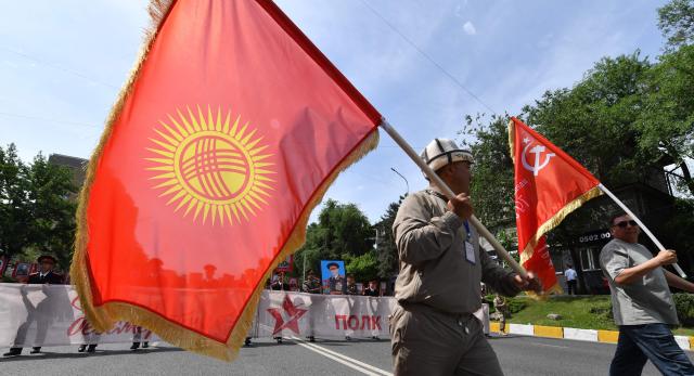 Participants carry portraits of World War Two soldiers during the Immortal Regiment march in Bishkek on May 9, 2026. Kyrgyzstan celebrates the 81st anniversary of the Allied victory over Nazi Germany in World War II. (Photo by Vyacheslav OSELEDKO / AFP)