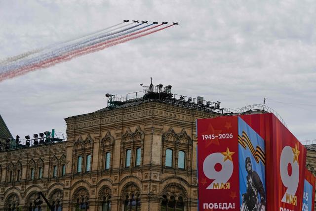 Russian Sukhoi SU-25 fighter jets release smoke in the colours of the Russian tricolor flag as they fly over central Moscow during the Victory Day military parade on May 9, 2026. Russia celebrates the 81st anniversary of the Soviet Union's victory over Nazi Germany in World War Two (WWII). (Photo by Alexander Zemlianichenko / POOL / AFP)