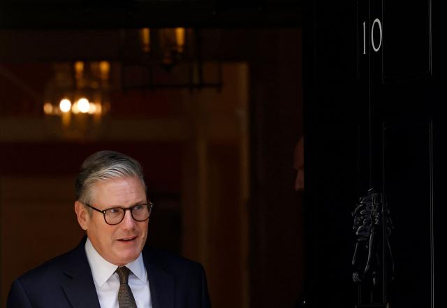 (FILES) Britain's Prime Minister Keir Starmer steps out to greet Barbados Prime Minister, at the door to 10 Downing Street, in central London, on April 4, 2025 ahead of a bilateral meeting. British Prime Minister Keir Starmer promised on May 9, 2026, he would "listen to voters" after his Labour party received a historic drubbing in local and regional elections. (Photo by BENJAMIN CREMEL / AFP)