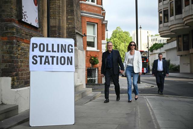 (FILES) Britain's Prime Minister Keir Starmer (L) arrives with his wife Victoria Starmer (C) to cast their votes at a polling station in Westminster Chapel, central London on May 7, 2026, as polls open for local elections. British Prime Minister Keir Starmer promised on May 9, 2026, he would "listen to voters" after his Labour party received a historic drubbing in local and regional elections. (Photo by JUSTIN TALLIS / AFP)