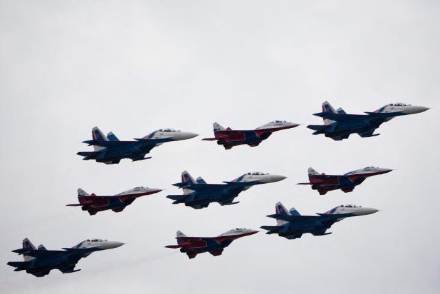 Russia's MiG-29 jet fighters of the Strizhi (Swifts) and Su-30SM jet fighters of the Russkiye Vityazi (Russian Knights) aerobatic teams fly in formation over central Moscow during the Victory Day military parade on May 9, 2026. Russia celebrates the 81st anniversary of the Soviet Union's victory over Nazi Germany in World War Two (WWII). (Photo by Pavel Bednyakov / POOL / AFP)