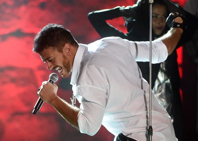 (FILES) Morocco singer Saad Lamjarred performs during the 52 sesion of the International Carthage Festival on July 30, 2016 at the romain theatre of carthage near Tunis. Moroccan singer Saad Lamjarred, already implicated in several cases of rape or sexual assault, is on trial before the Draguignan (Var) Assize Court for the rape, which he denies, of a barmaid in 2018 near Saint-Tropez. (Photo by FETHI BELAID / AFP)