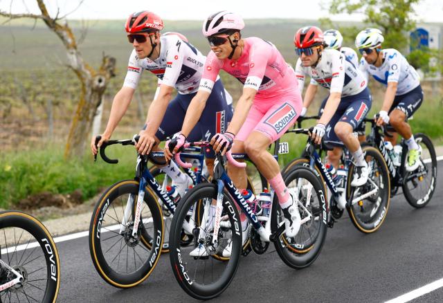 Soudal Quick-Step French rider Paul Magnier (R) wearing the overall leader's pink jersey (Maglia Rosa) rides flanked by his teammate Soudal Quick-Step Belgian rider Ayco Bastiaens during the 2nd stage of the Giro d'Italia 2026 - Tour of Italy cycling race between Burgas and Veliko Tarnovo, Bulgaria, on May 9, 2026. (Photo by Luca Bettini / AFP)