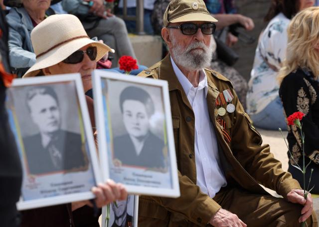 Red Army veterans participate alongside relatives and supporters in a ceremony to commemorate the 81th anniversary of the Victory over Germany in World War II, at the Victory Monument commemorating the Red Army's victory over Nazi Germany, in the Israeli coastal city of Netanya on May 9, 2026. (Photo by JACK GUEZ / AFP)