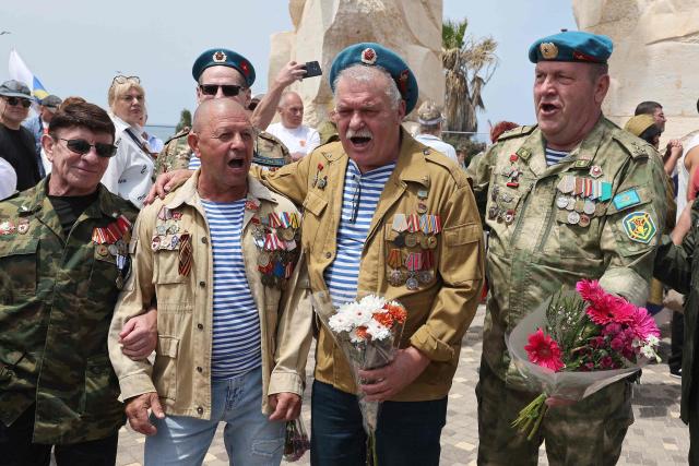 Red Army veterans participate alongside relatives and supporters during a ceremony to commemorate the 81th anniversary of the Victory over Germany in World War II, at the Victory Monument commemorating the Red Army's victory over Nazi Germany, in the Israeli coastal city of Netanya on May 9, 2026. (Photo by JACK GUEZ / AFP)