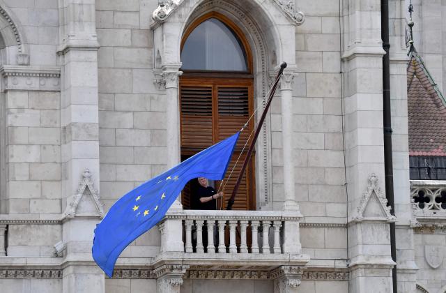 The flag of the European Union (EU) is placed at the building of the Hungarian Parliament, after the newly appointed parliament speaker ordered the EU flag be hung back on the building in Budapest on May 9, 2026, ending the flag's long absence under Viktor Orban, who was voted from power in mid-April 2026. Pro-European conservative Peter Magyar will be officially sworn in as Prime Minister by the Hungarian parliament on May 9, 2026, just under a month after his landslide victory in the parliamentary elections against nationalist Viktor Orban. (Photo by Ferenc ISZA / AFP)