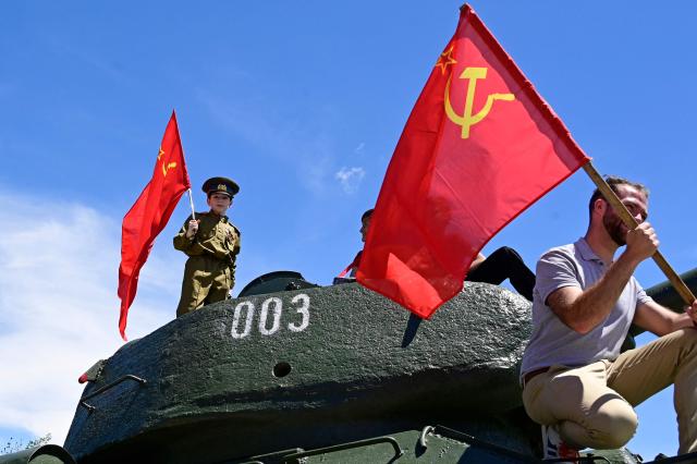 Boys play atop a T-34-85 tank during a ceremony marking the 81st anniversary of the victory over Nazi Germany in World War II in Yerevan on May 9, 2026. (Photo by KAREN MINASYAN / AFP)