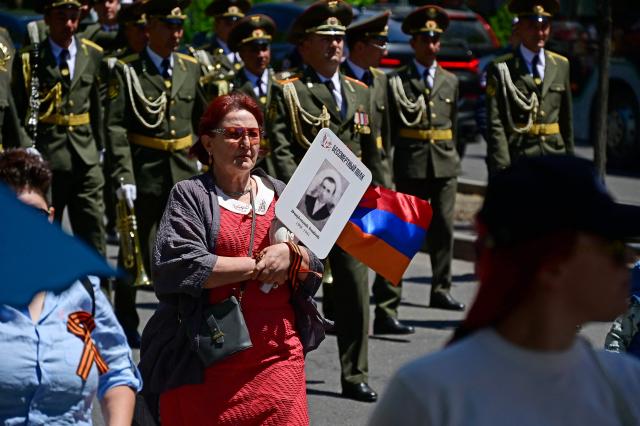 Participants carry portraits of World War Two soldiers during the Immortal Regiment march in Yerevan on May 9, 2026. Armenia celebrates the 81st anniversary of the Allied victory over Nazi Germany in World War II. (Photo by KAREN MINASYAN / AFP)