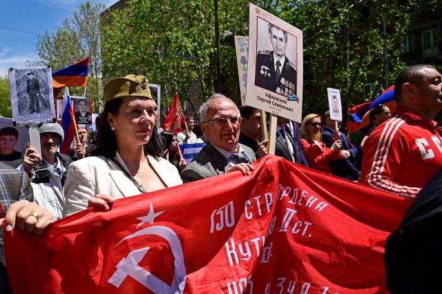 Participants carry portraits of World War Two soldiers during the Immortal Regiment march in Yerevan on May 9, 2026. Armenia celebrates the 81st anniversary of the Allied victory over Nazi Germany in World War II. (Photo by KAREN MINASYAN / AFP)