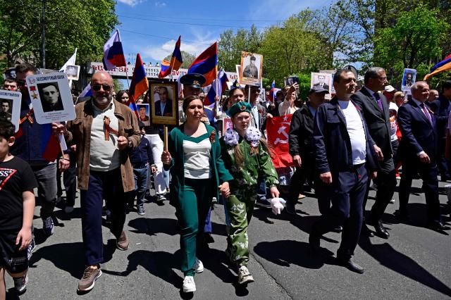 Participants carry portraits of World War Two soldiers during the Immortal Regiment march in Yerevan on May 9, 2026. Armenia celebrates the 81st anniversary of the Allied victory over Nazi Germany in World War II. (Photo by KAREN MINASYAN / AFP)