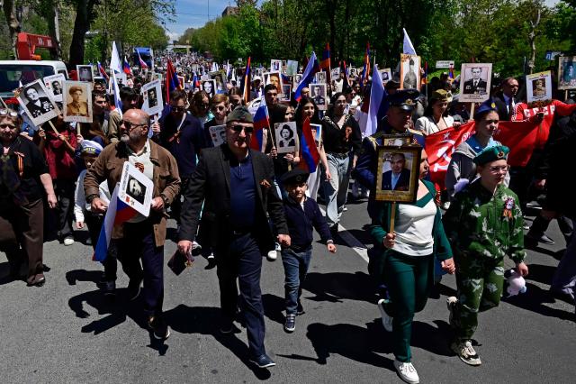 Participants carry portraits of World War Two soldiers during the Immortal Regiment march in Yerevan on May 9, 2026. Armenia celebrates the 81st anniversary of the Allied victory over Nazi Germany in World War II. (Photo by KAREN MINASYAN / AFP)