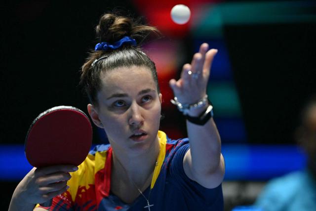 Romania's Andreea Dragoman serves against China's Kuai Man during their Women's Teams semi-final match at the ITTF World Table Tennis Championships in Wembley Arena, west London on May 9, 2026. (Photo by Glyn KIRK / AFP)