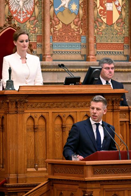 Hungary's incoming Prime Minister Peter Magyar (C) delivers a speech as incoming speaker of the Hungarian parliament Agnes Forsthoffer (L, up) looks on during his swearing-in ceremony at the Hungarian parliament in Budapest on May 9, 2026. Pro-European conservative Peter Magyar will be officially sworn in as Prime Minister by the Hungarian parliament on May 9, 2026, just under a month after his landslide victory in the parliamentary elections against nationalist Viktor Orban. (Photo by Attila KISBENEDEK / AFP)