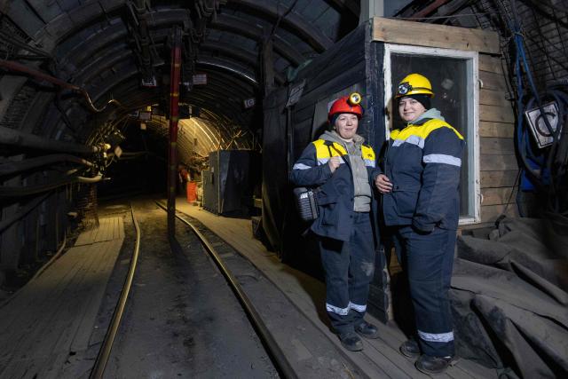 Employee Oksana and intern Olha pose for a photo at a coal mine operated by Ukrainian energy provider DTEK at an undisclosed location in the Dnipropetrovsk region on May 5, 2026, amid the Russian invasion of Ukraine. (Photo by Serhii Okunev / AFP)