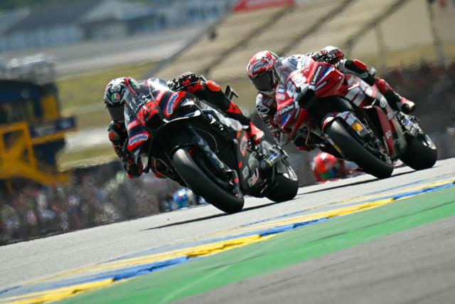 Aprilia Racing's Italian rider Marco Bezzecchi (L) leads Ducati Lenovo Team's Italian rider Francesco Bagnaia (R) during the Moto GP Grand Prix of France Sprint race at Le Mans, northwestern France, on May 9, 2026. (Photo by Loic VENANCE / AFP)