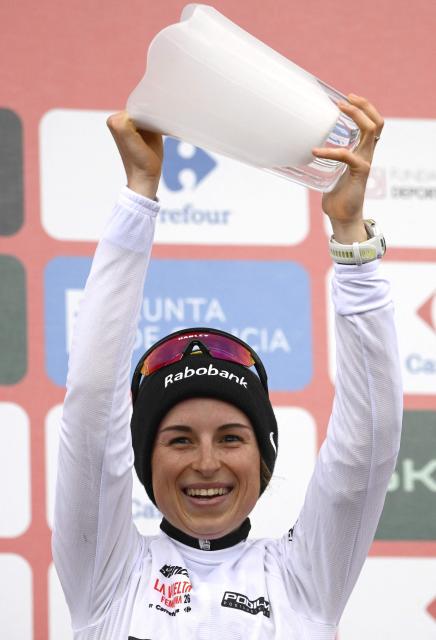 Third placed of 2026 La Vuelta Femenina cycling tour of Spain, team Team Visma - Lease a Bike's French rider Marion Bunel celebrates on the podium after the 7th stage, a 132.9 km race between Pola de Laviana and Alto de l'Angliru, on May 9, 2026. (Photo by Miguel RIOPA / AFP)