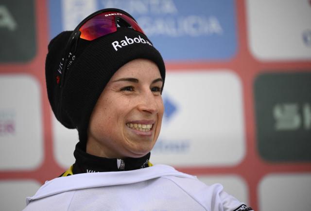 Third placed of 2026 La Vuelta Femenina cycling tour of Spain, team Team Visma - Lease a Bike's French rider Marion Bunel celebrates on the podium after the 7th stage, a 132.9 km race between Pola de Laviana and Alto de l'Angliru, on May 9, 2026. (Photo by Miguel RIOPA / AFP)