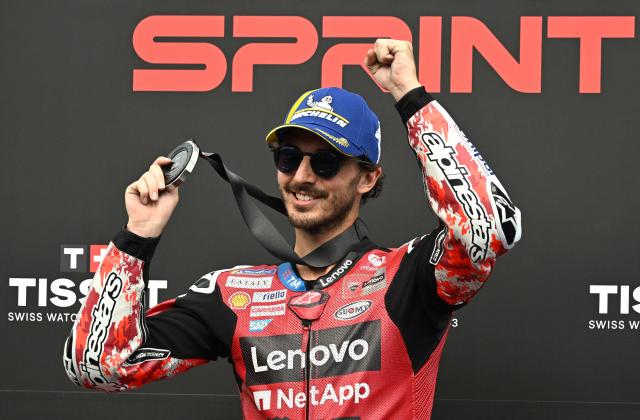 Ducati Lenovo Team's Italian rider Francesco Bagnaia celebrates on the podium after finishing second in the Moto GP Grand Prix of France Sprint race at Le Mans, northwestern France, on May 9, 2026. (Photo by Loic VENANCE / AFP)