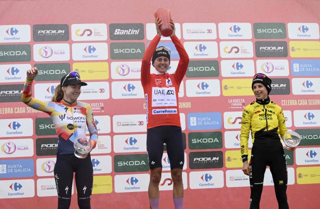 Winner of 2026 La Vuelta Femenina cycling tour of Spain, team UAE ADQ's Spanish rider Paula Blasi Cairol, second placed team SD Worx - Protime's Dutch rider Anna van der Breggen (L) and third placed Team Visma - Lease a Bike's French rider Marion Bunel (R) celebrate on the podium after the 7th stage, a 132.9 km race between Pola de Laviana and Alto de l'Angliru, on May 9, 2026. (Photo by Miguel RIOPA / AFP)