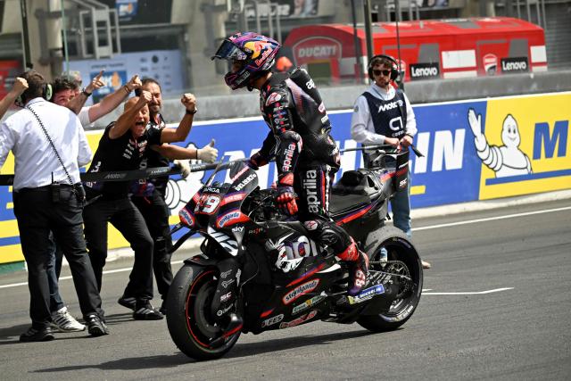 Aprilia Racing's Spanish rider Jorge Martin (C) celebrates with his team in parc ferme after winning the Moto GP Grand Prix of France Sprint race at Le Mans, northwestern France, on May 9, 2026. (Photo by Loic VENANCE / AFP)