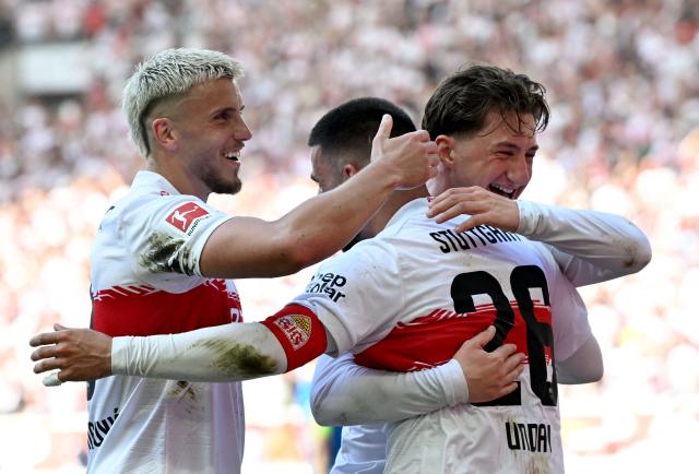 Stuttgart's German forward #26 Deniz Undav (C) celebrates with Stuttgart's Bosnian forward #09 Ermedin Demirovic (L) and Stuttgart's German midfielder #06 Angelo Stiller (R) after scoring the 3-1 goal during the German first division Bundesliga football match between VfB Stuttgart and Bayer 04 Leverkusen in Stuttgart, southwestern Germany on May 9, 2026. (Photo by THOMAS KIENZLE / AFP) / DFL REGULATIONS PROHIBIT ANY USE OF PHOTOGRAPHS AS IMAGE SEQUENCES AND/OR QUASI-VIDEO