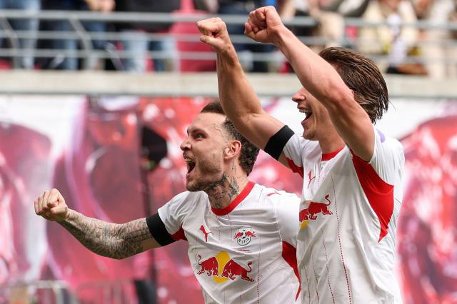 Leipzig's Hungarian defender #04 Willi Orban (R) celebrates scoring the 2-0 goal with his teammate Leipzig's German defender #22 David Raum during the German first division Bundesliga football match between RB Leipzig and St Pauli in Leipzig, eastern Germany, on May 9, 2026. (Photo by Odd ANDERSEN / AFP) / DFL REGULATIONS PROHIBIT ANY USE OF PHOTOGRAPHS AS IMAGE SEQUENCES AND/OR QUASI-VIDEO  ALTERNATIVE CROP