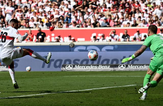 Stuttgart's German forward #26 Deniz Undav (L) shoots the ball to score the 3-1 goal against Bayer Leverkusen's Dutch goalkeeper #01 Mark Flekken (R) during the German first division Bundesliga football match between VfB Stuttgart and Bayer 04 Leverkusen in Stuttgart, southwestern Germany on May 9, 2026. (Photo by THOMAS KIENZLE / AFP) / DFL REGULATIONS PROHIBIT ANY USE OF PHOTOGRAPHS AS IMAGE SEQUENCES AND/OR QUASI-VIDEO
