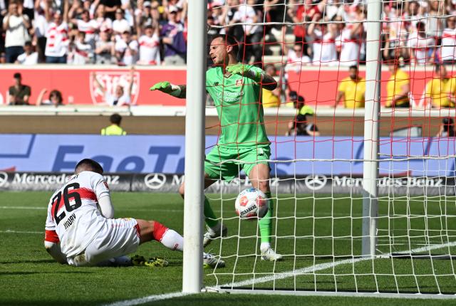Bayer Leverkusen's Dutch goalkeeper #01 Mark Flekken (R) reacts as Stuttgart's German forward #26 Deniz Undav scores the 3-1 goal during the German first division Bundesliga football match between VfB Stuttgart and Bayer 04 Leverkusen in Stuttgart, southwestern Germany on May 9, 2026. (Photo by THOMAS KIENZLE / AFP) / DFL REGULATIONS PROHIBIT ANY USE OF PHOTOGRAPHS AS IMAGE SEQUENCES AND/OR QUASI-VIDEO