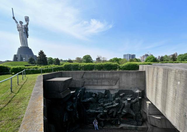 A visitor looks at the sculptures at the National Museum of the History of Ukraine in the World War II, marking the Victory Day over Nazism in World War II, in Kyiv on May 9, 2026, amid the Russian invasion of Ukraine. (Photo by Sergei SUPINSKY / AFP)