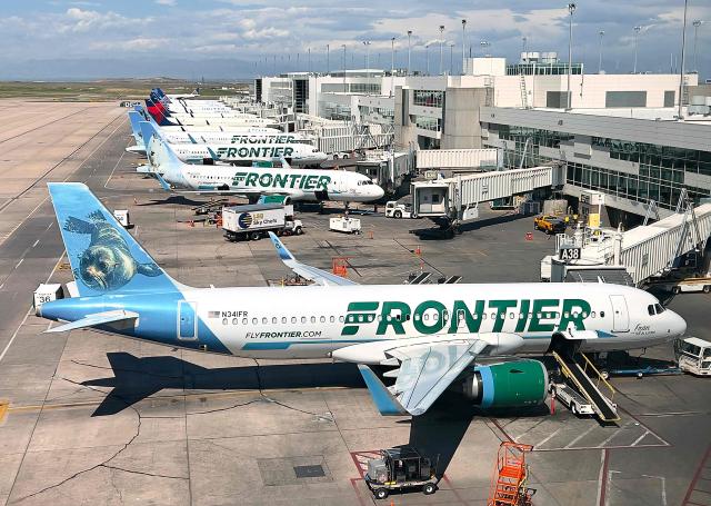 (FILES) Frontier Airlines planes are parked at gates in Denver International Airport (DEN) in Denver, Colorado, on August 5, 2023. A flight aborted its takeoff from Denver International Airport late Friday on May 8, 2026 after striking a person on the runway, with at least one passenger injured, according to the airport and US media reports. (Photo by Daniel SLIM / AFP)