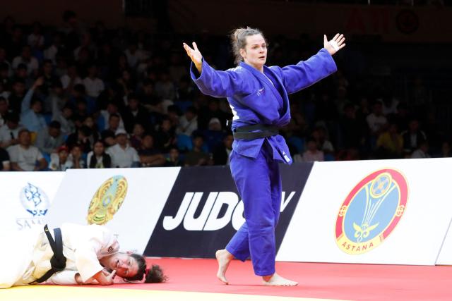 France's Clemence Eme reacts past Germany's Miriam Butkereit (white) after winning the women's under 70 kg final bout at the Astana Grand Slam judo tournament in Astana on May 9, 2026. (Photo by STANISLAV FILIPPOV / AFP)
