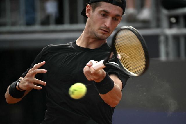French Terence Atman hits a return to Italy's Flavio Cobolli during the ATP Rome Open tennis tournament at Foro Italico in Rome on May 9, 2026. (Photo by Filippo MONTEFORTE / AFP)