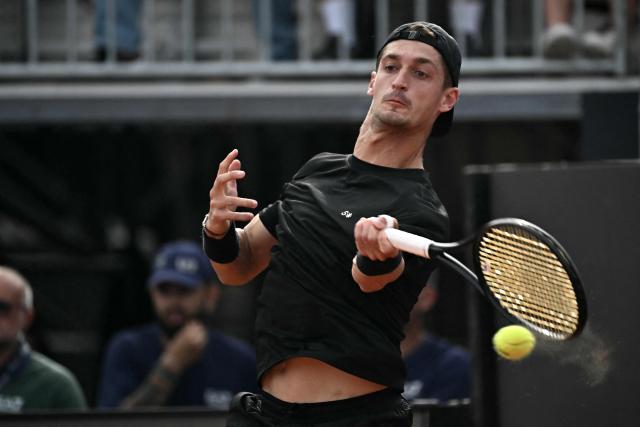 French Terence Atman hits a return to Italy's Flavio Cobolli during the ATP Rome Open tennis tournament at Foro Italico in Rome on May 9, 2026. (Photo by Filippo MONTEFORTE / AFP)