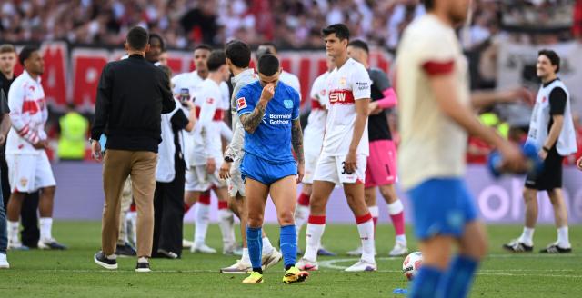 Bayer Leverkusen's Spanish defender #20 Alejandro Grimaldo (C) leaves the pitch after the German first division Bundesliga football match between VfB Stuttgart and Bayer 04 Leverkusen in Stuttgart, southwestern Germany on May 9, 2026. (Photo by THOMAS KIENZLE / AFP) / DFL REGULATIONS PROHIBIT ANY USE OF PHOTOGRAPHS AS IMAGE SEQUENCES AND/OR QUASI-VIDEO