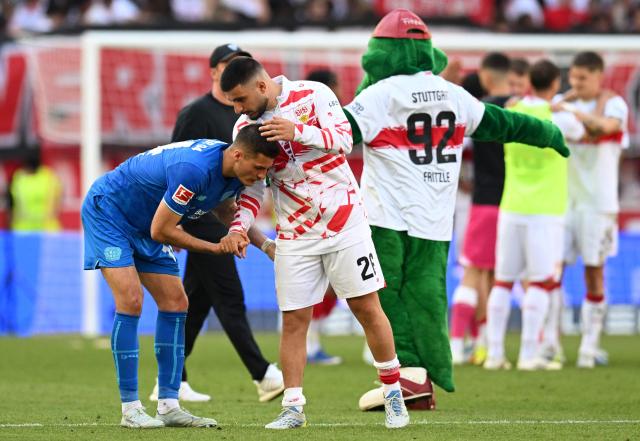 Stuttgart's German forward #26 Deniz Undav (2nd L) comforts Bayer Leverkusen's Czech forward #14 Patrik Schick (L) after the German first division Bundesliga football match between VfB Stuttgart and Bayer 04 Leverkusen in Stuttgart, southwestern Germany on May 9, 2026. (Photo by THOMAS KIENZLE / AFP) / DFL REGULATIONS PROHIBIT ANY USE OF PHOTOGRAPHS AS IMAGE SEQUENCES AND/OR QUASI-VIDEO