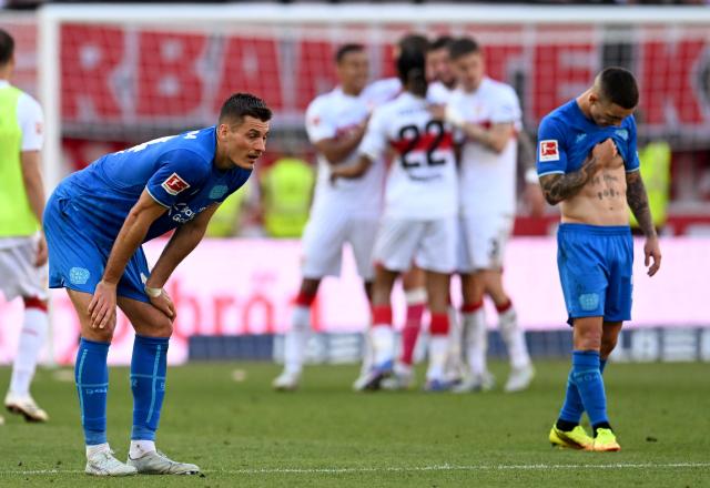Bayer Leverkusen's Czech forward #14 Patrik Schick (L) and Bayer Leverkusen's Spanish defender #20 Alejandro Grimaldo  stand on the pitch after the German first division Bundesliga football match between VfB Stuttgart and Bayer 04 Leverkusen in Stuttgart, southwestern Germany on May 9, 2026. (Photo by THOMAS KIENZLE / AFP) / DFL REGULATIONS PROHIBIT ANY USE OF PHOTOGRAPHS AS IMAGE SEQUENCES AND/OR QUASI-VIDEO
