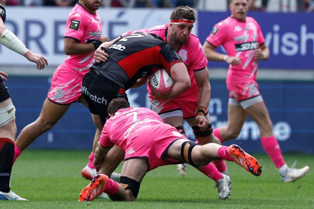 Lyon's French hooker Mathis Sarragallet is tackled by Stade Français' French lock Baptiste Pesenti (R) and Stade Français' French flanker Romain Briatte (down) during the French Top 14 rugby union match between Stade Francais and Lyon Olympique Universitaire Rugby at the Jean Bouin Stadium in Paris on May 9, 2026. (Photo by SIMON WOHLFAHRT / AFP)