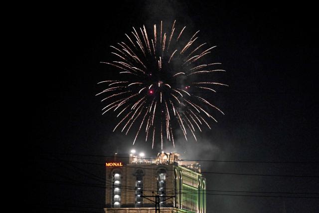 People burst firecrackers from the rooftop of a building in Islamabad on May 9, 2026 marking one year since the India-Pakistan conflict. (Photo by Farooq NAEEM / AFP)