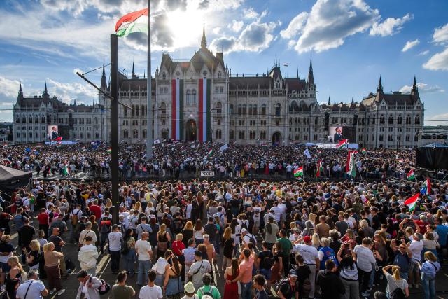 TOPSHOT - People attend Hungary's incoming Prime Minister Peter Magyar's swearing-in ceremony outside the Hungarian parliament in Budapest on May 9, 2026. Lawmakers in Hungary on May 9, 2026 swore in pro-European conservative Peter Magyar as the country's new prime minister, after elections last month that ended Viktor Orban's 16 years in power. The parliament formally elected Magyar with 140 votes for, 54 against, and one abstention in the inaugural session of the new chamber resulting from the April polls. (Photo by Ferenc ISZA / AFP)
