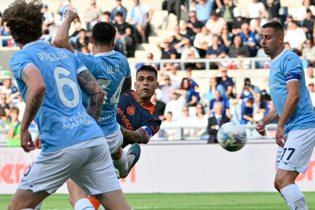 Inter Milan's Argentine forward #10 Lautaro Martinez (C) eyes the ball as he scores his team's first goal during the Italian Serie A football match between Lazio and InterMilan at the Olympic stadium in Rome on May 9, 2026. (Photo by Alberto PIZZOLI / AFP)