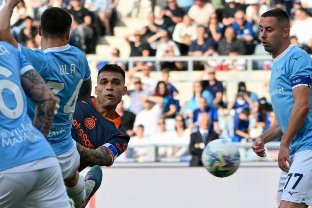 Inter Milan's Argentine forward #10 Lautaro Martinez (C) eyes the ball as he scores his team's first goal during the Italian Serie A football match between Lazio and InterMilan at the Olympic stadium in Rome on May 9, 2026. (Photo by Alberto PIZZOLI / AFP)