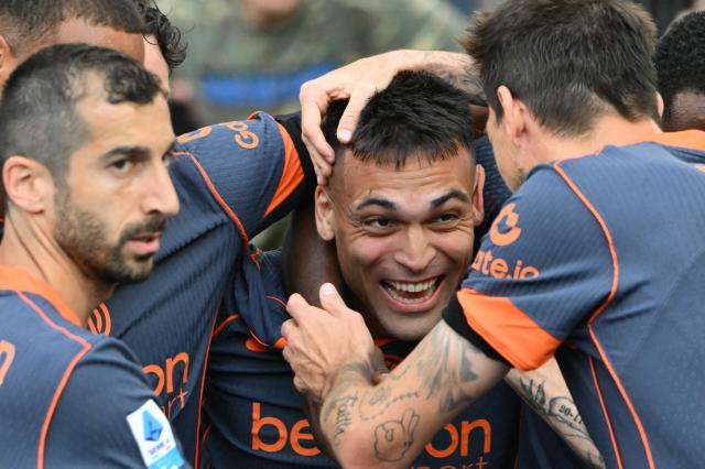 TOPSHOT - Inter Milan's Argentine forward #10 Lautaro Martinez (C) celebrates with teammates after scoring his team's first goal during the Italian Serie A football match between Lazio and InterMilan at the Olympic stadium in Rome on May 9, 2026. (Photo by Alberto PIZZOLI / AFP)