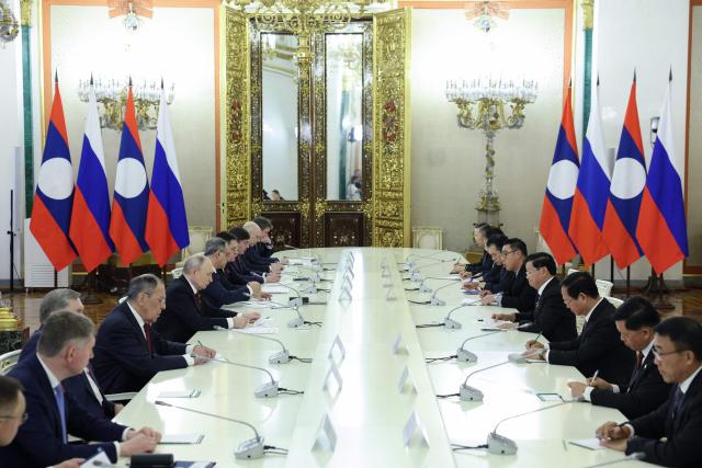 Russian President Vladimir Putin and Laotian President Thongloun Sisoulith attend a meeting at the Kremlin in Moscow on May 9, 2026. (Photo by Ramil Sitdikov / POOL / AFP)